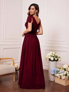 Detailed view of burgundy V-neck evening gown with elegant shoulder bow tie design