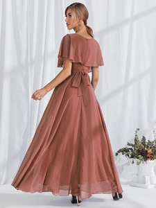 Detailed back view of dusty rose Swiss dot evening gown featuring a large waist bow tie