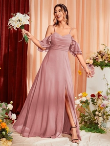 Detail of elegant dusty rose evening dress featuring cold-shoulder ruffles and high leg slit