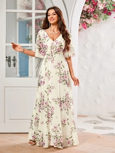 Close-up of elegant V-neck floral dress with purple and green patterns on white chiffon