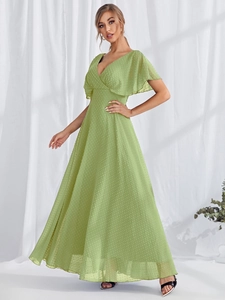 Detail of light green V-neck maxi dress featuring flutter sleeves and Swiss dot texture