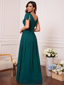 Deep green V-neck evening gown with elegant bow shoulder details and a pleated waistline
