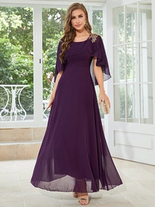 Detailed close-up of dark purple chiffon evening gown featuring golden floral embroidery