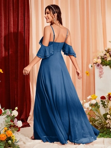 Detail of cold-shoulder ruffles and adjustable straps on a dark blue evening maxi dress