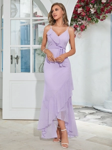 Detail of light purple chiffon dress with Swiss dots, V-neck, and ruffled hem in sunlight