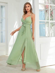 Detail of light green slip maxi dress with V-neck knot design and side high slit