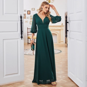 Detail of elegant dark green maxi dress featuring a deep V-neck and lantern sleeves