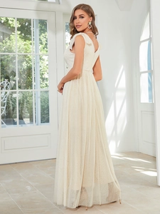 Detailed close-up of cream lace bodice and tiered point d'esprit tulle on bridesmaid dress
