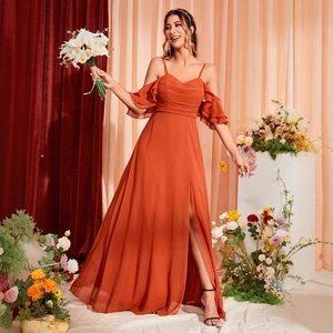 Elegant orange spaghetti strap evening gown with ruffle cold-shoulder and high split