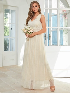 Close-up of elegant V-neck lace bodice and polka dot tulle skirt of the bridesmaid dress