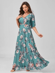 Detail of V-neck floral maxi dress with ruffle sleeves and elegant green chiffon print