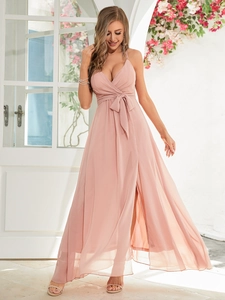 Detail of elegant V-neck strap dress with waist tie and high slit in pale pink chiffon