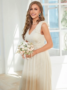 Detail of elegant V-neck lace bodice and layered mesh skirt on an ivory bridesmaid dress