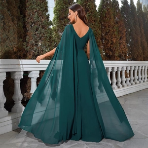 Elegant emerald green V-neck backless evening gown with flowing matching cape detail