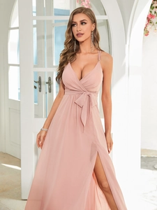 Detail of elegant V-neck evening dress with waist bow tie and high slit chiffon skirt