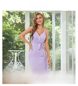 Detail of lavender v-neck dress featuring polka dot texture and waist ribbon tie