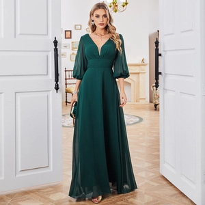 Detail view of the elegant deep green chiffon gown with V-neckline and sheer lantern sleeves