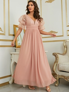 Detail of pink evening dress with lace V-neck bodice and translucent puff sleeves