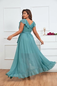 Detail of teal chiffon maxi dress featuring elegant V-neck and ruffled sleeve design