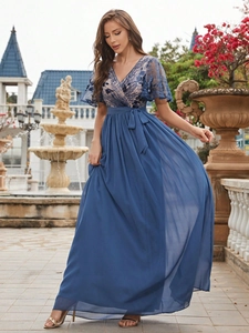 Close-up of dark blue lace embroidery and elegant bow ribbon on the chiffon evening gown