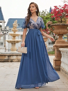 Detailed view of elegant blue evening gown with lace embroidery and pleated chiffon skirt