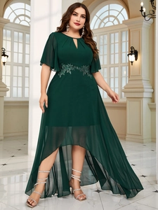 Close-up of floral lace embroidery and waist details on a dark green chiffon evening dress