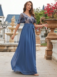 Detail of elegant navy blue evening gown showing delicate lace floral embroidery on bodice