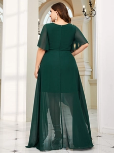 Detail of elegant dark green chiffon evening gown featuring flutter sleeves and layered hem