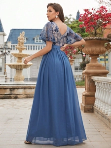 Detail of elegant navy blue evening gown featuring lace embroidery and chiffon skirt