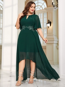 Detail of dark green evening dress featuring delicate floral lace waist embroidery