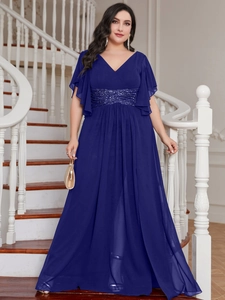 Detail of elegant V-neck dark blue gown with sequins on ruffled sleeves and waist