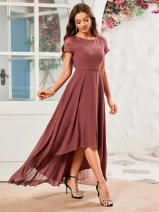 Detail of elegant dusty rose chiffon dress with round neck and intricate lace stitching