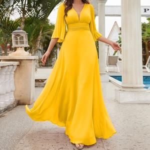 Detail of elegant yellow V-neck maxi dress featuring pleated sleeves and a flowing chiffon skirt