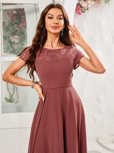 Detailed view of the elegant lace floral neckline and short sleeves on a dusty pink gown