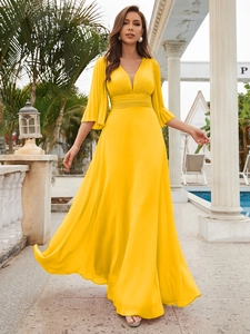 Detail of elegant V-neck yellow chiffon dress featuring pleated waist and umbrella sleeves