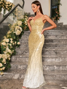 Detail of elegant gold sequin evening gown with deep V-neck and mermaid hemline