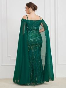 Close-up of sequined embroidery and flowing chiffon cape sleeves on a green gown