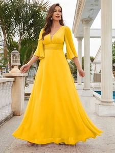 Detailed view of yellow V-neck chiffon evening gown with elegant pleated waist and butterfly sleeves