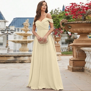 Close-up of off-shoulder pleated bodice and chiffon texture on an elegant cream evening gown