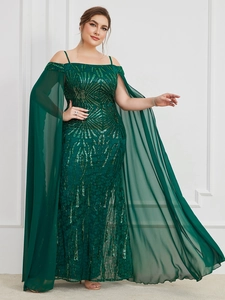 Close-up of sequined dark green evening dress with chiffon sleeves and glitter patterns