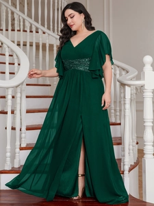 Detail view of dark green V-neck dress with sequin waist and elegant high side slit