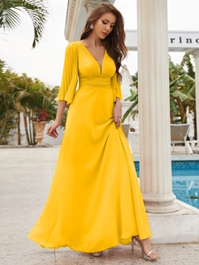 Detailed view of elegant V-neck yellow chiffon evening dress with pleated mid-length sleeves