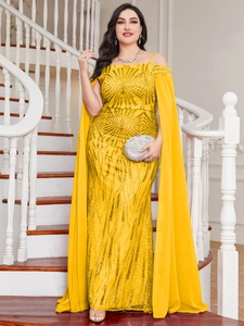Detail of yellow sequin evening gown showing off-shoulder straps and cape train