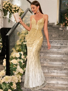 Detail of golden sequin evening dress with deep V-neck and mermaid hem on model