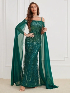 Detail of emerald green sequined evening gown with long chiffon cape sleeves and off-shoulder