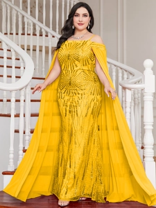 Detail of elegant yellow mermaid gown with luxury sequins and matching long mesh shawl