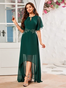 Dettaglio dell'abito in chiffon verde scuro con applique floreali e scollatura a goccia