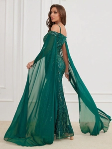 Detailed view of emerald green off-shoulder sequins dress with elegant chiffon cape sleeves