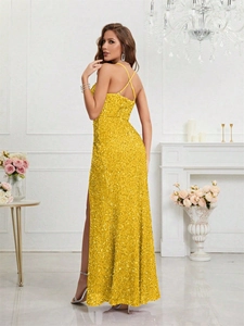 Détail d'une robe de soirée à paillettes dorées avec bretelles croisées et fente haute
