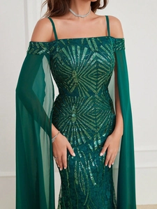 Detail of green sequin gown showing the boat neck design and flowing chiffon sleeves